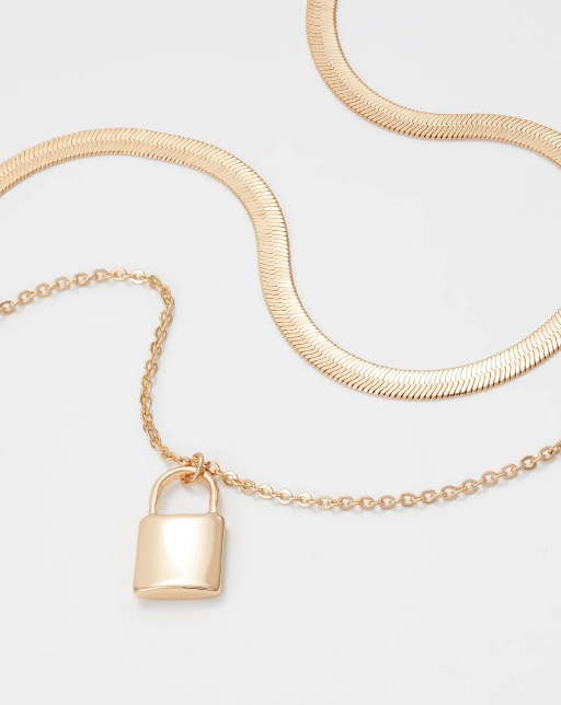 closeup of serpentine pattern and padlock of golden necklaces