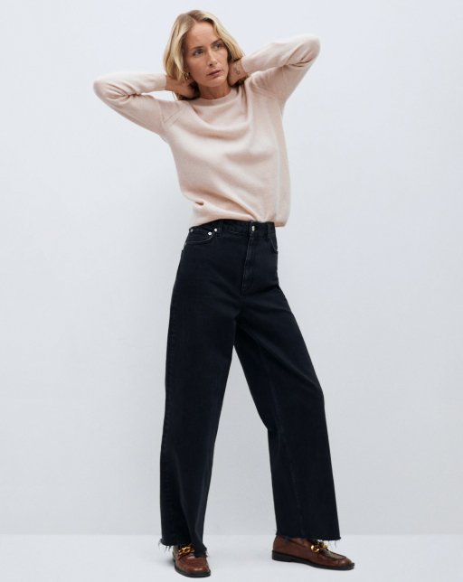 standing view of model wearing tan sweater